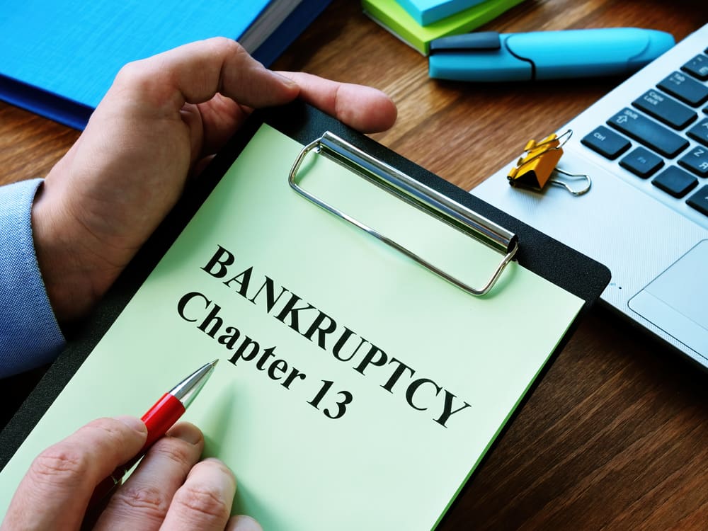 Person Pointing With A Pen On Bankruptcy Chapter 13 title