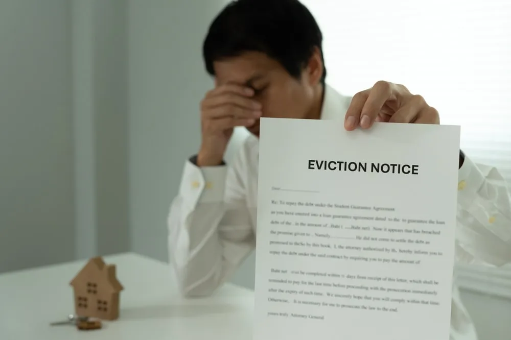 Person Holding Eviction Notice Paper